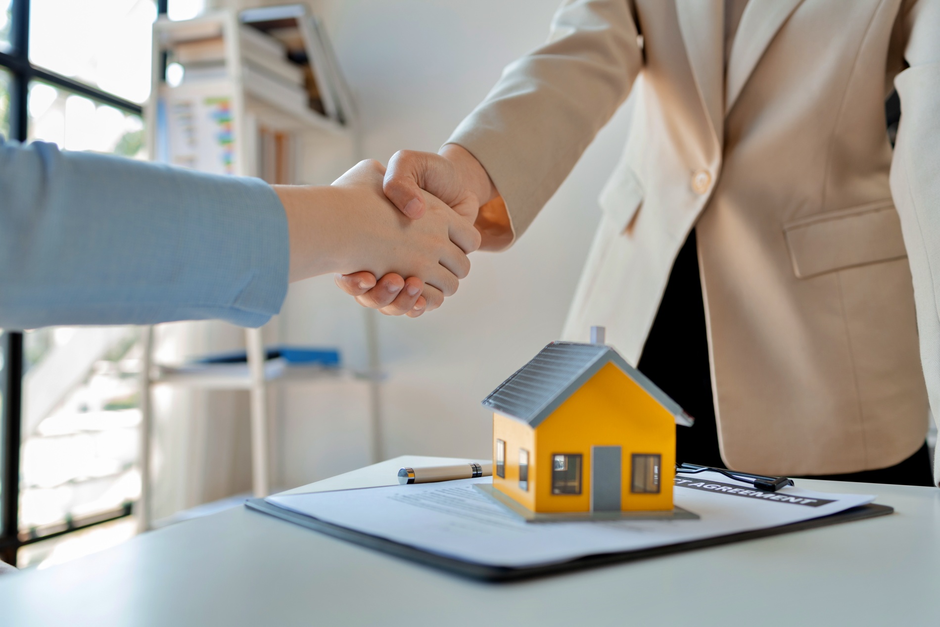 Property owner shaking hands in a business agreement with a property manager.