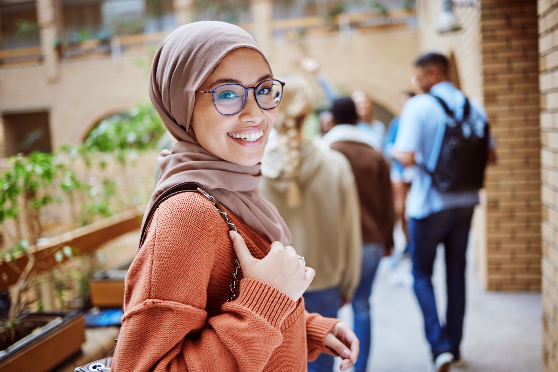 Muslim female university student walking to class.