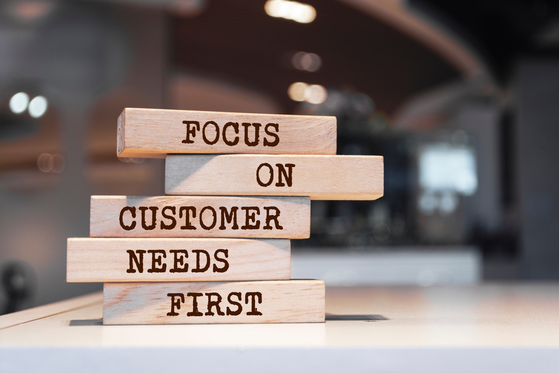 Wooden blocks with words "Focus on customer needs first"